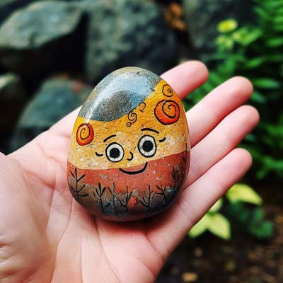 face painted on a rock