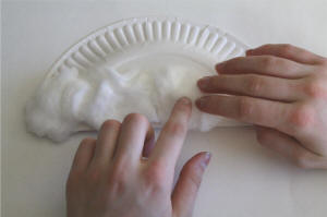 Cover one half of the paper plate in cotton balls.