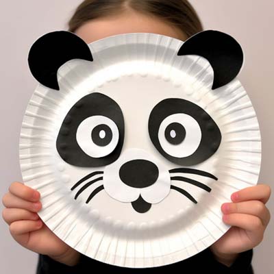 Paper Plate Panda Craft held by a child