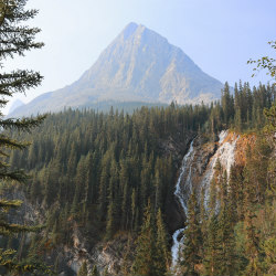 mountain and waterfall landscape along the moderate hiking trail at Grassi Lake in Canmore, Alberta, Canada