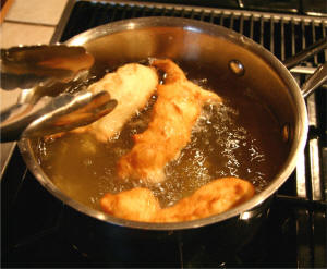 Fry the dough in fat turning to brown both sides.