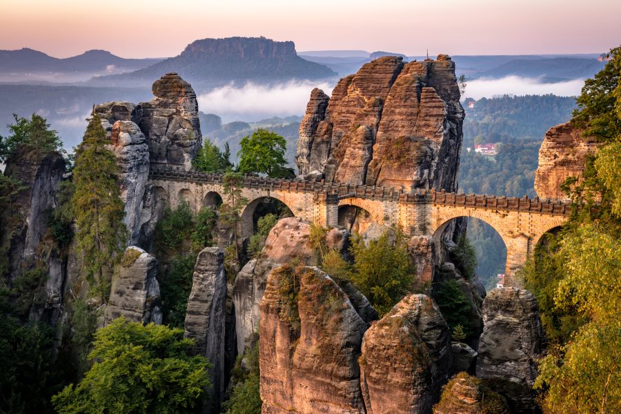 image of a massive, ancient-looking bridge amidst the miraculous rock formations of Saxon Switzerland, Germany, also known as Bastei